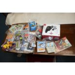 A Nintendo Switch controller, one game and quantity of trading cards.