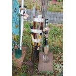 A quantity of garden tools including rake, hoe, lawn edgers, small hand forks, etc.