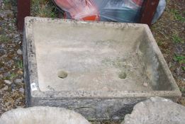 A concrete planter in the form of a sink, 27'' x 20'' x 7'' deep.