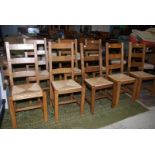 A contemporary set of eight Oak and other woods ladderback Dining Chairs having drop-in seagrass