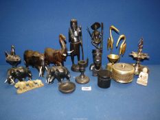 A quantity of carved Elephants, oriental and ethnic figures, ebonised candlestick and pin dish,