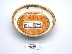 A rare Vienna 'faux bois' porcelain saucer painted in sepia with a landscape scene with the