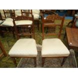 A pair of Edwardian satinwood framed side Chairs standing on turned legs and having turned and