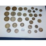 A quantity of silver coins including Victoria, Edward VII and George V shillings, florins,