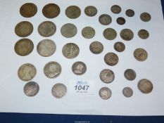 A quantity of silver coins including Victoria, Edward VII and George V shillings, florins,