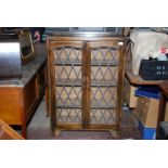 A floorstanding darkwood Cabinet having a pair of opposing lead lattice glazed doors,