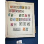 A green Stanley Gibbons 'Ideal' Stamp Album; Part I - B.E.C.