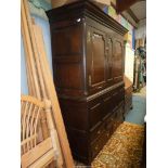 A most substantial peg joined dark Oak cupboard on chest having a pair of opposing doors with