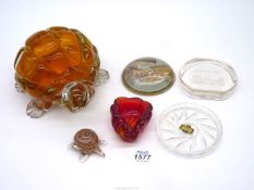 A quantity of paperweights and dishes including a large tortoise with orange body,