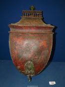 A wall mounted tin water Container painted red, lidded and with a tap,