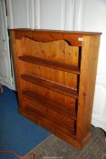 A floor standing Pine Bookshelves flanked by fluted columns/supports,