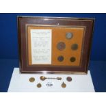 A framed set of five antique coins to include George II shilling, William & Mary farthing, etc.