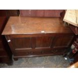 A three panel Oak Blanket Chest, with two lower short drawers, standing on bracket feet,