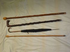 Three walking sticks - one with spiral cut, two with smooth knops,
