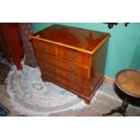 A compact Yewwood and other woods contemporary Chest of three long and two short drawers having