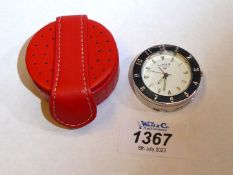 A Links of London travel alarm clock in red leather branded case.