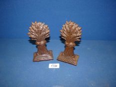 A pair of unusual salt glazed 19th century fireplace ornaments in the form of wheat sheaves on