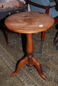 A circular Pine tavern type Table standing on a turned pillar with three splay feet,