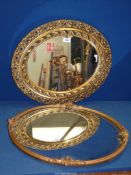 Two oval wooden carved mirrors painted with gilt, both with some damage, 22" x 18" approx.