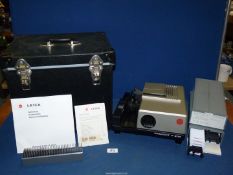 A cased Leica Pradovit P300 slide projector with instructions and slides, some of Switzerland, etc.