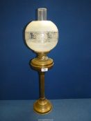 A brass oil lamp with brass reservoir and etched and frosted glass shade, 27" tall.
