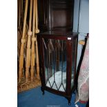 A dark Mahogany bow fronted Display Cabinet having a cross-banded top and standing on brief