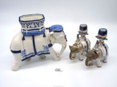 A Royal Worcester blue and white elephant, a/f and a pair of candle holders with nodding heads.