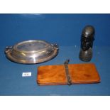 A vintage wooden tie press, carved ethnic head and a plated serving dish with lid.