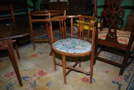 An Edwardian Beechwood framed bowed back Corner/side Chair standing on turned legs/arm supports and