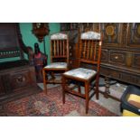 A pair of Edwardian Mahogany framed side Chairs standing on tapering square legs,