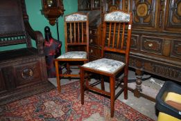 A pair of Edwardian Mahogany framed side Chairs standing on tapering square legs,