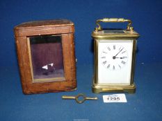 A brass Carriage Clock in leather case, with key.