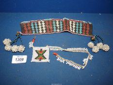 An old Zulu traditional bead work arm band with wood toggles,