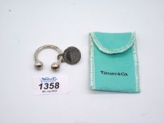 A Tiffany & Co. 925 silver Keyring in turquoise pouch with a 'Please return to Tiffany & Co.'tag.