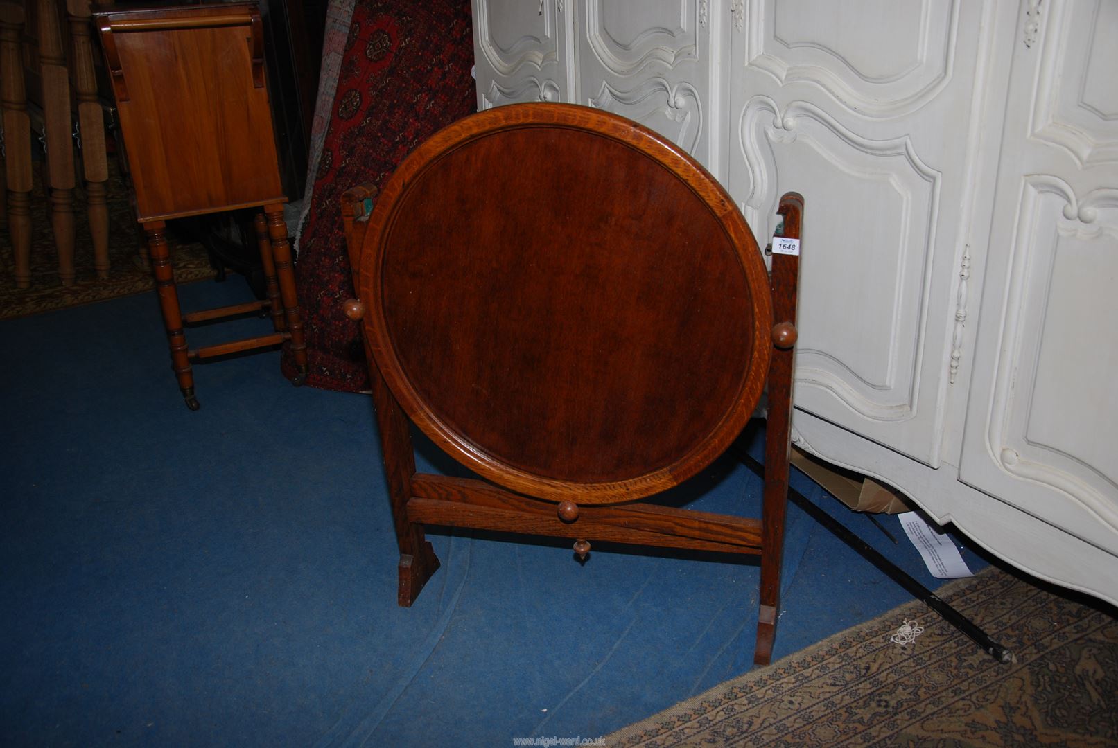 An Oak metamorphic Firescreen/Table, 25 3/4'' wide x 33 1/2'' high converting to a circular table,