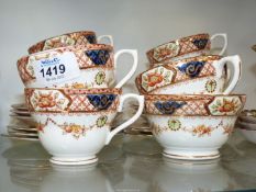 A Sutherland china tea set; six each cups, saucers and tea plates and a milk jug and sugar bowl.