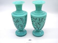 A pair of turquoise blue opaque glass vases with hand painted overlay featuring foliate and insect