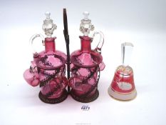 A cranberry liqueur set consisted of two decanters and six matching cups in fitted ornate metal
