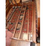 A mid Oak wall hanging plate rack having shaped ends (one strut requires re-attachment),