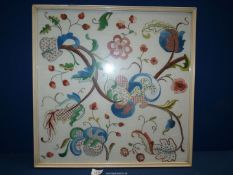 A framed contemporary embroidery of stylised flowers, 21'' square.