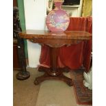 A 19th century Regency design Mahogany flap over card table standing on a tapering octagonal pillar