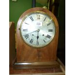 A large wooden cased striking Mantle Clock with silvered dial.