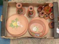 A quantity of terracotta Watcombe Pottery including plates, Long Park Torquay Candlesticks, etc.