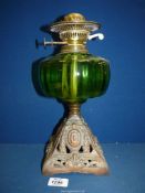 A square based Oil Lamp with green glass reservoir, no chimney or shade.