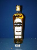A 70 cl bottle of Bushmills Irish Whisky, triple distilled.