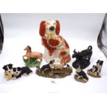 A Mantle spaniel, four border collie figures, Staffordshire flatbacks and black ceramic cow creamer.