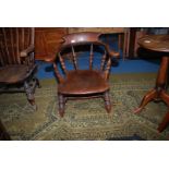 A principally Elm Captains Armchair having turned legs, stretchers and back supports,