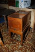 A tambour topped Oak Filing Cabinet/Chest standing on a base with perimeter stretchers,