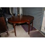 A Georgian Mahogany swing leg dropleaf Dining Table standing on square legs,