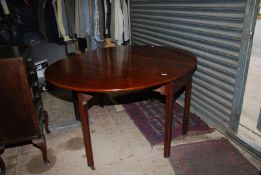 A Georgian Mahogany swing leg dropleaf Dining Table standing on square legs,
